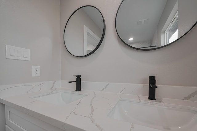 details featuring a sink, double vanity, and visible vents