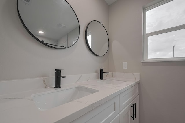 full bath featuring double vanity and a sink
