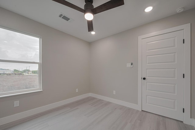 empty room featuring recessed lighting, baseboards, ceiling fan, visible vents, and light wood-type flooring