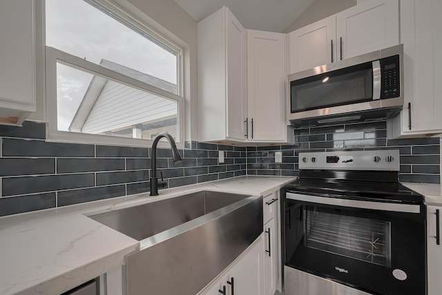 kitchen featuring white cabinetry, stainless steel appliances, and a sink