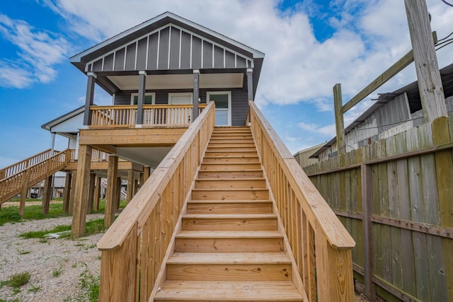 rear view of property featuring stairs