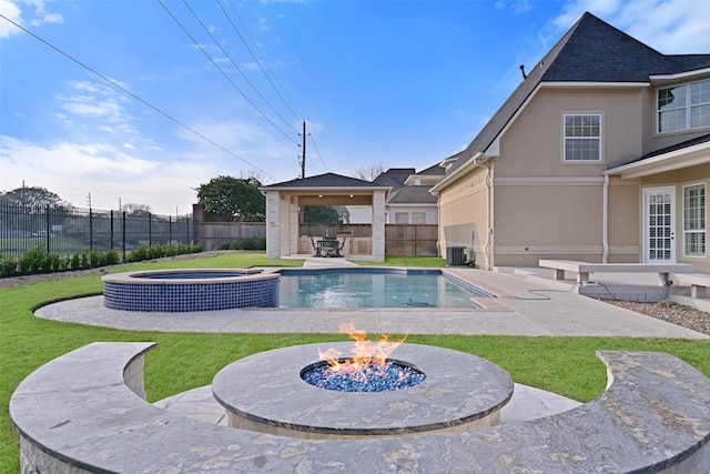 view of swimming pool with a gazebo, a fenced backyard, an in ground hot tub, a fenced in pool, and an outdoor fire pit