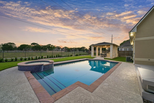 view of swimming pool with a pool with connected hot tub, central air condition unit, a patio area, a gazebo, and a fenced backyard