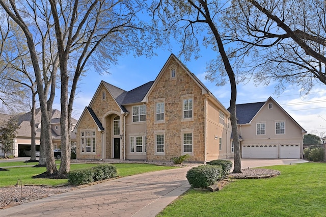 view of front facade featuring concrete driveway, stone siding, a front yard, and a garage