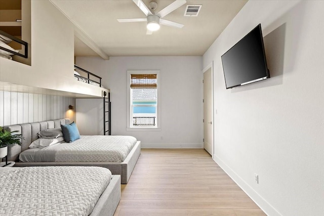 bedroom with light wood-type flooring, visible vents, baseboards, and a ceiling fan