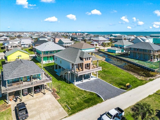 birds eye view of property with a water view and a residential view