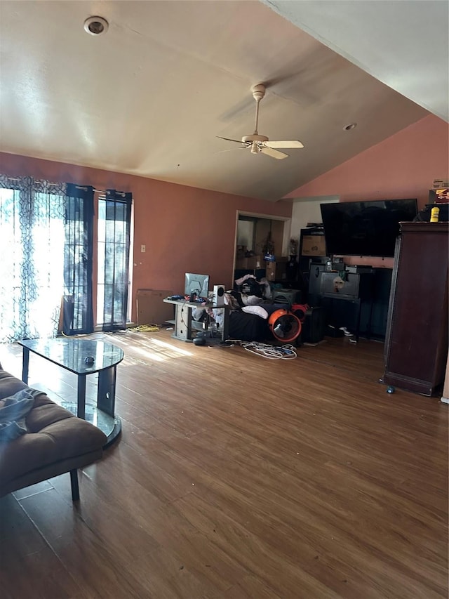 living room featuring a ceiling fan, lofted ceiling, and wood finished floors