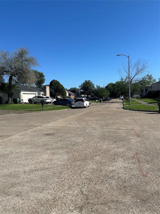 view of street with street lights and curbs