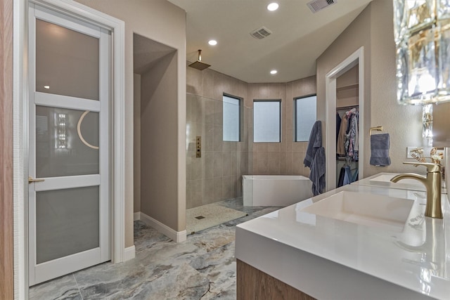 18787 Serene Water Dr, Montgomery, TX 77356 - bathroom with walk in shower, marble finish floor, vanity, visible vents, and recessed lighting
