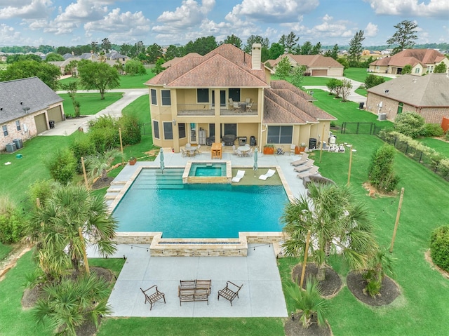 18787 Serene Water Dr, Montgomery, TX 77356 - view of pool featuring a yard, a patio, a pool with connected hot tub, an outdoor hangout area, and a fenced backyard