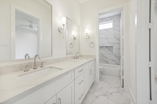 519 W 27th St, Houston, TX 77008 - full bathroom featuring double vanity, toilet, marble finish floor, and a sink
