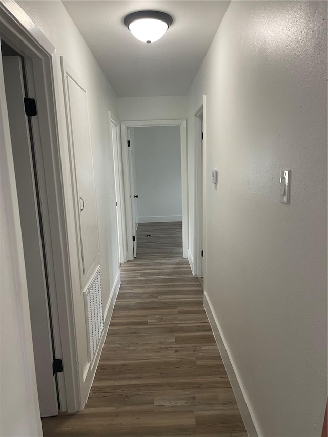 1107 Dover Cir, Alvin, TX 77511 - corridor featuring baseboards and dark wood-style flooring