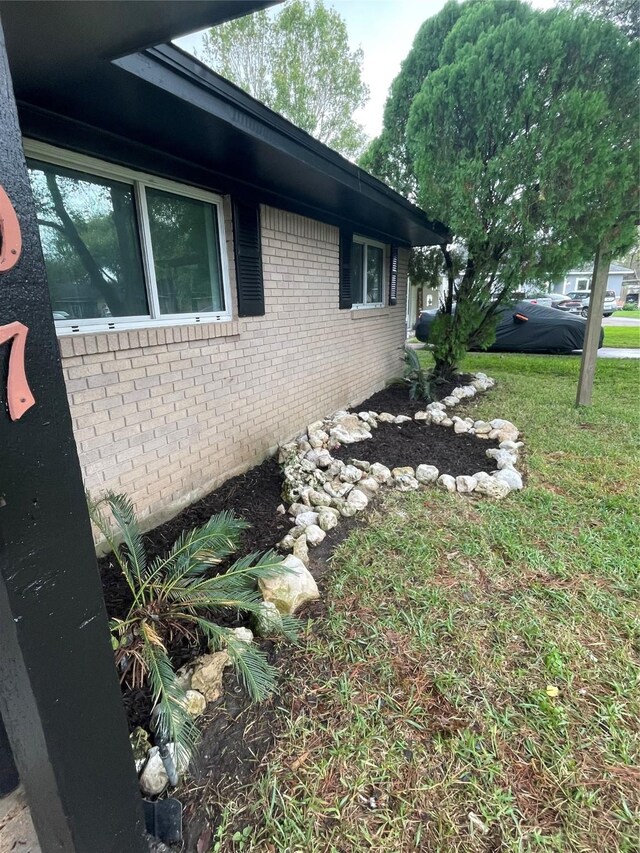 1107 Dover Cir, Alvin, TX 77511 - view of property exterior with brick siding and a yard