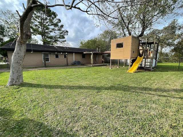 1107 Dover Cir, Alvin, TX 77511 - back of property with a playground, central AC unit, and brick siding