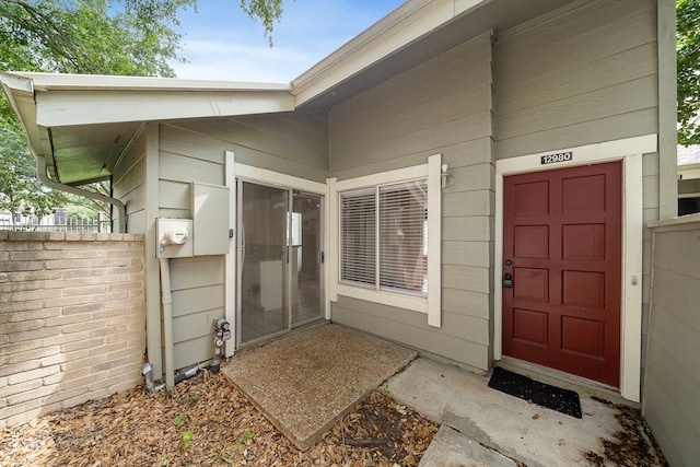 view of exterior entry with fence