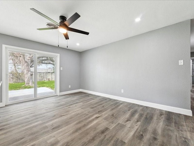 empty room with baseboards, recessed lighting, a ceiling fan, and wood finished floors