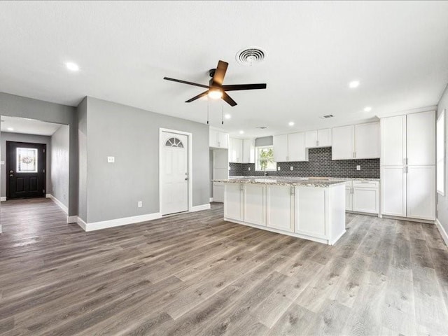 kitchen with white cabinetry, recessed lighting, and visible vents