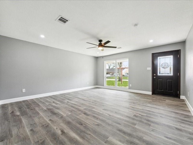 unfurnished living room with a ceiling fan, recessed lighting, baseboards, visible vents, and wood finished floors