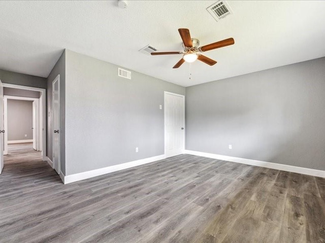unfurnished room featuring baseboards, visible vents, and a ceiling fan