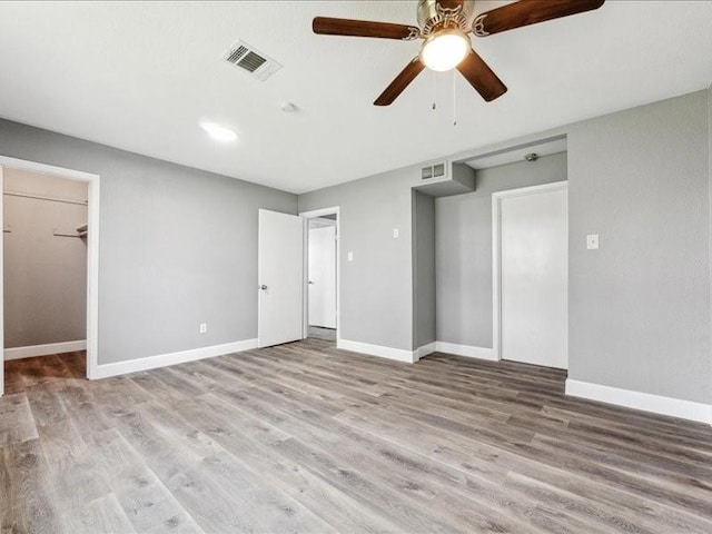 interior space featuring visible vents, wood finished floors, and baseboards