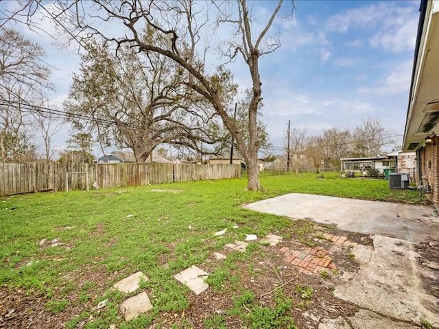 view of yard featuring central AC, a patio, and a fenced backyard