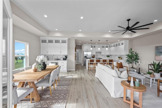 living area with light wood-style floors, recessed lighting, and ceiling fan
