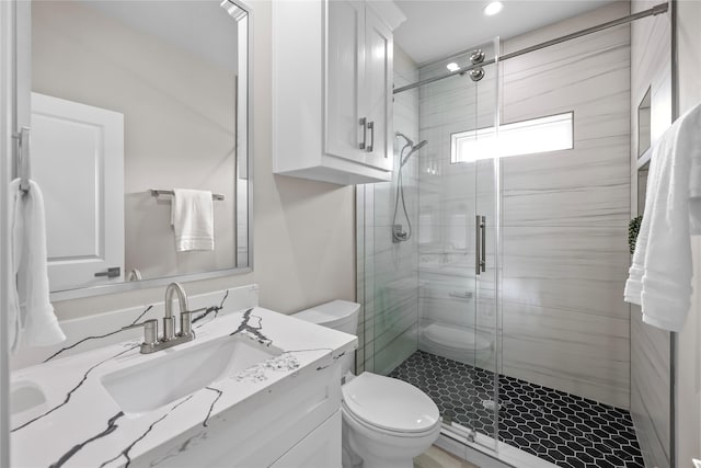 full bathroom with toilet, a stall shower, vanity, and recessed lighting