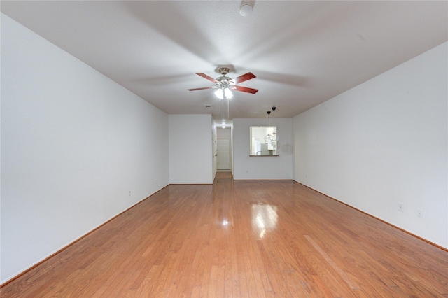 spare room featuring light wood finished floors and a ceiling fan