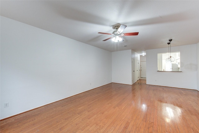 unfurnished living room with light wood-type flooring and a ceiling fan