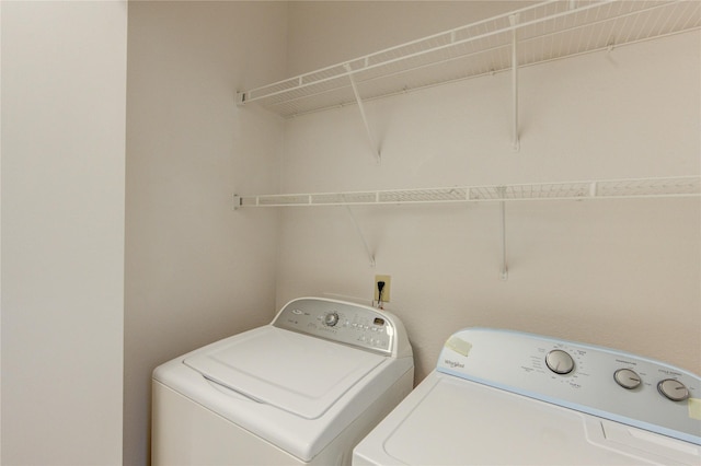 laundry room with washing machine and clothes dryer and laundry area