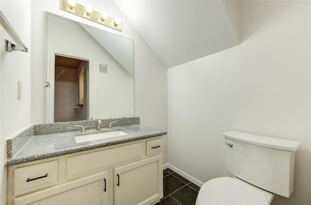 bathroom with toilet, tile patterned floors, visible vents, vaulted ceiling, and vanity