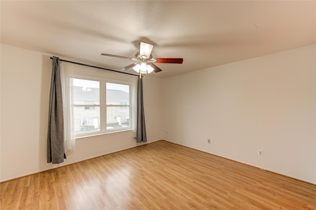 empty room with light wood-style flooring and a ceiling fan