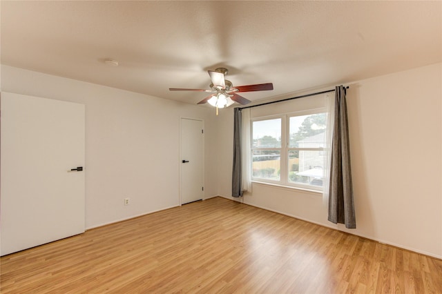 spare room with ceiling fan and light wood-style floors