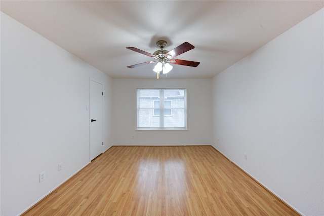 spare room featuring light wood-type flooring and a ceiling fan