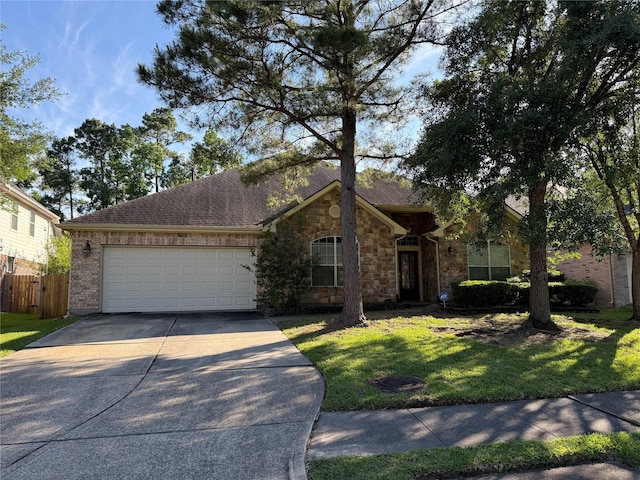 single story home with an attached garage, stone siding, fence, concrete driveway, and a front yard