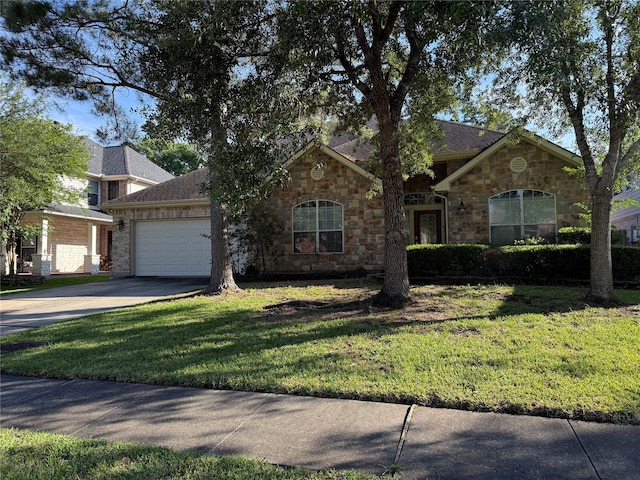 view of front of home with concrete driveway, stone siding, a front lawn, and a garage