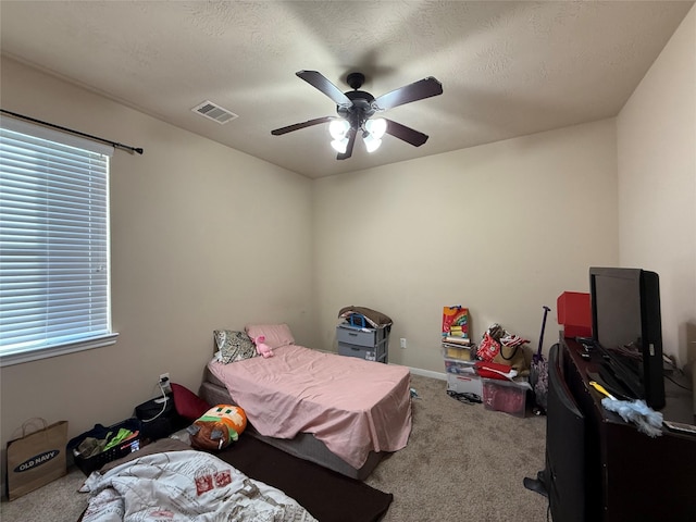 bedroom with carpet flooring, visible vents, baseboards, and a ceiling fan