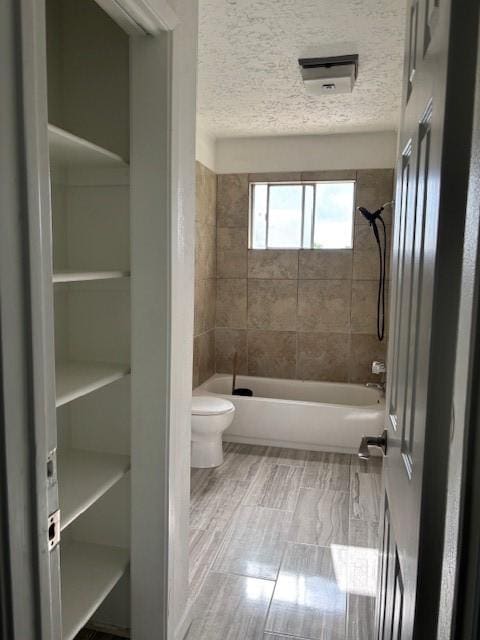 bathroom with toilet and shower / tub combination