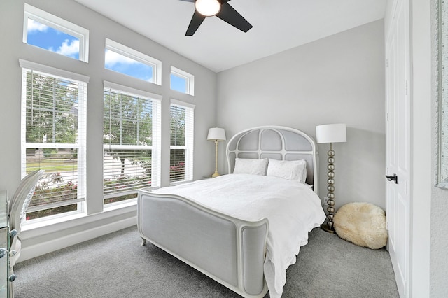 bedroom featuring baseboards, a ceiling fan, and carpet floors