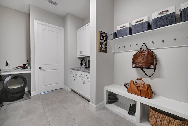 mudroom featuring visible vents, baseboards, and light tile patterned flooring