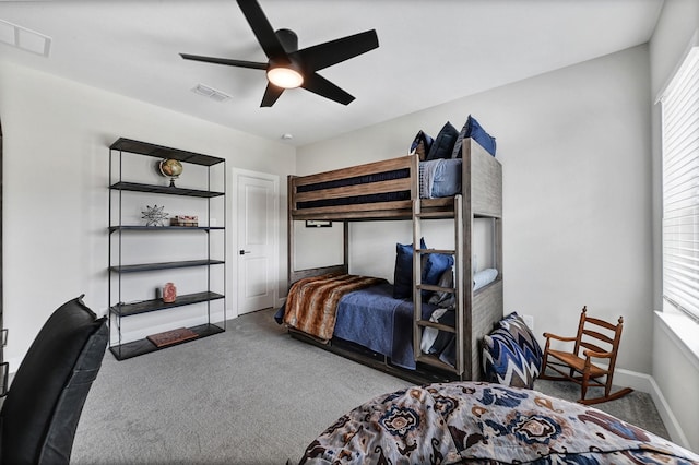 carpeted bedroom featuring visible vents, baseboards, and a ceiling fan