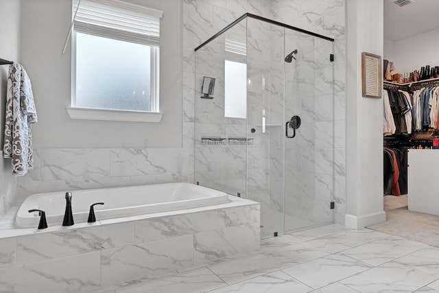 full bath with marble finish floor, visible vents, a shower stall, a walk in closet, and a bath
