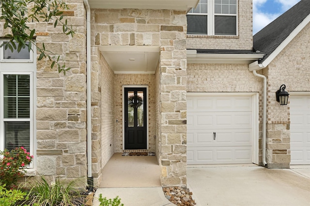 entrance to property with stone siding and a garage