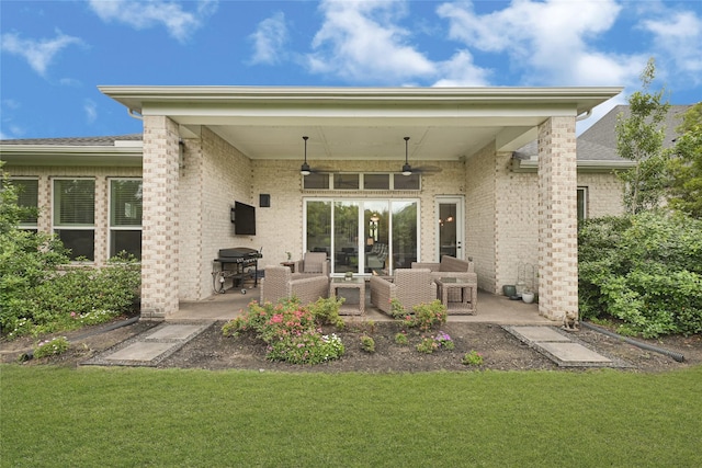 back of property with a yard, brick siding, outdoor lounge area, a patio, and ceiling fan