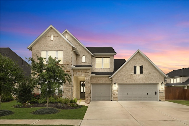 view of front of house featuring concrete driveway, a garage, fence, and brick siding