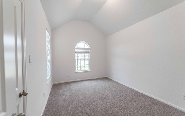 23403 Malbec Dr, Alvin, TX 77511 - empty room with carpet, vaulted ceiling, and baseboards