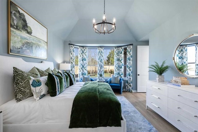bedroom with a chandelier, lofted ceiling, access to outside, and wood finished floors