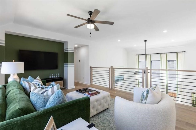 living area with wood finished floors, ceiling fan, and recessed lighting