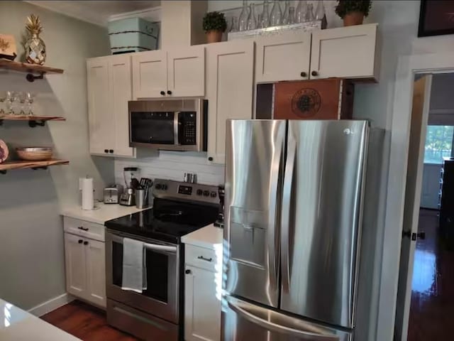 kitchen with white cabinetry, light countertops, open shelves, and appliances with stainless steel finishes