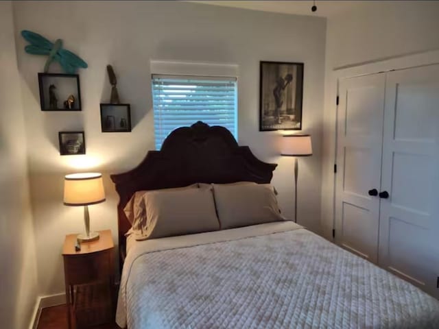 bedroom featuring a closet and baseboards